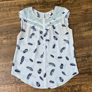 cute baby blue blouse with dark blue feathers. more dressy than casual.